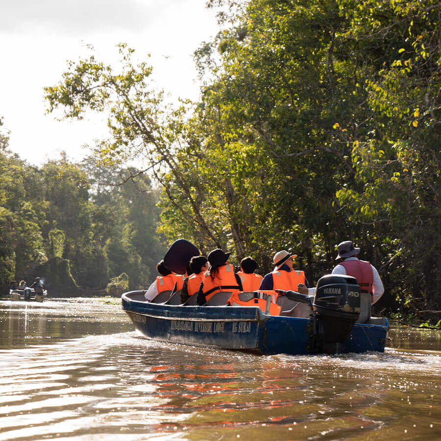 A group of people in a boat on a river.