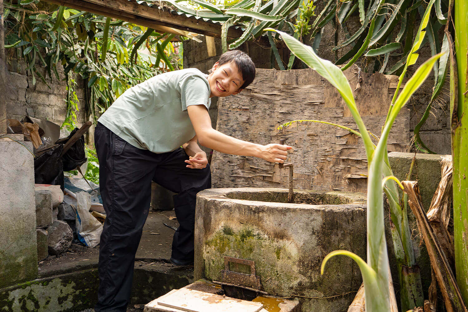 A man is standing next to a large water basin.
