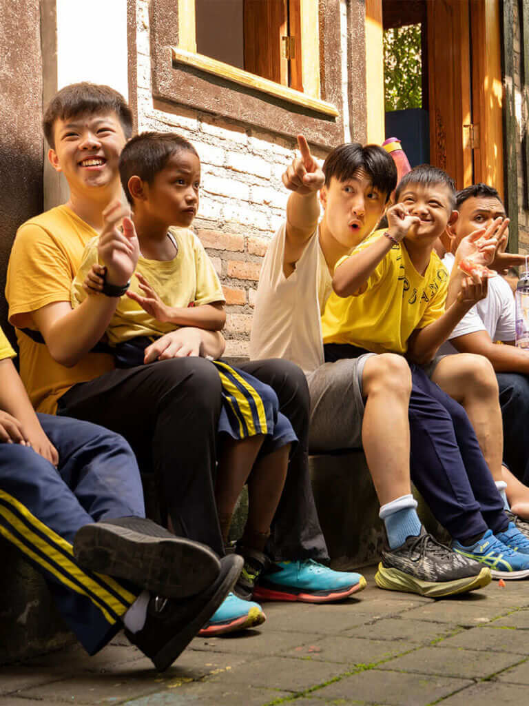 A group of people sitting on a bench.