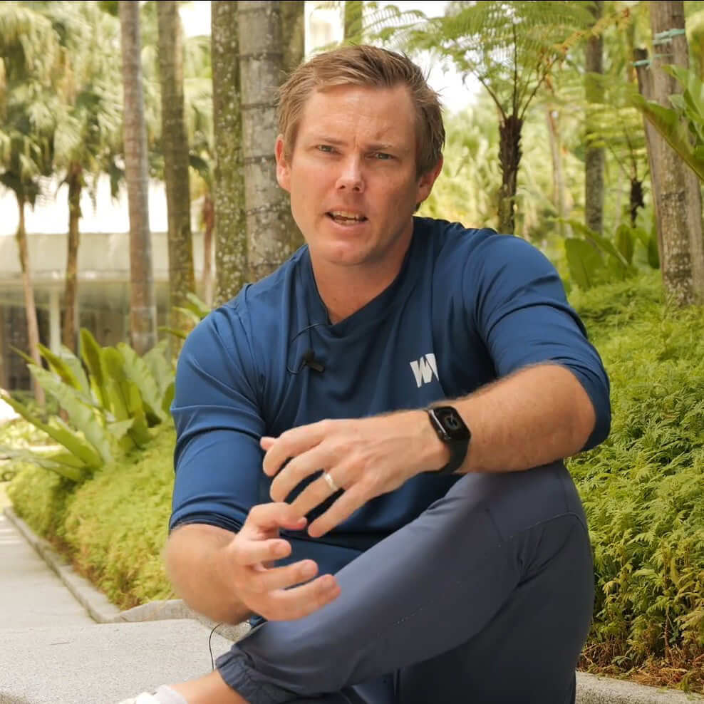 David sitting on bench speaking to camera